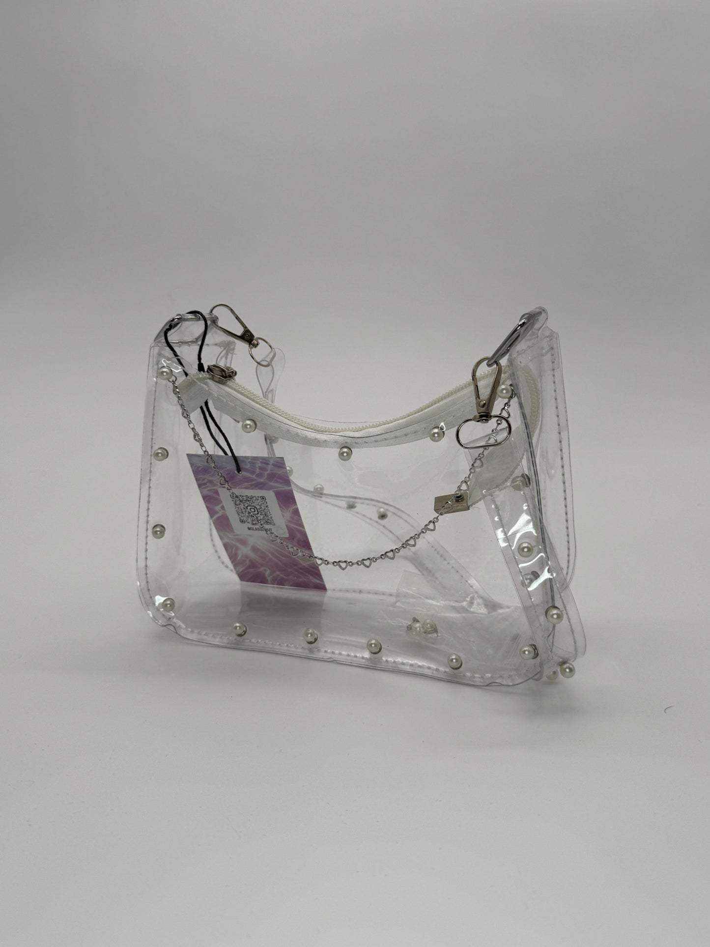 Clear jelly handbag with pearl studs on the front and across shoulder strap, and steel heart accent chain
