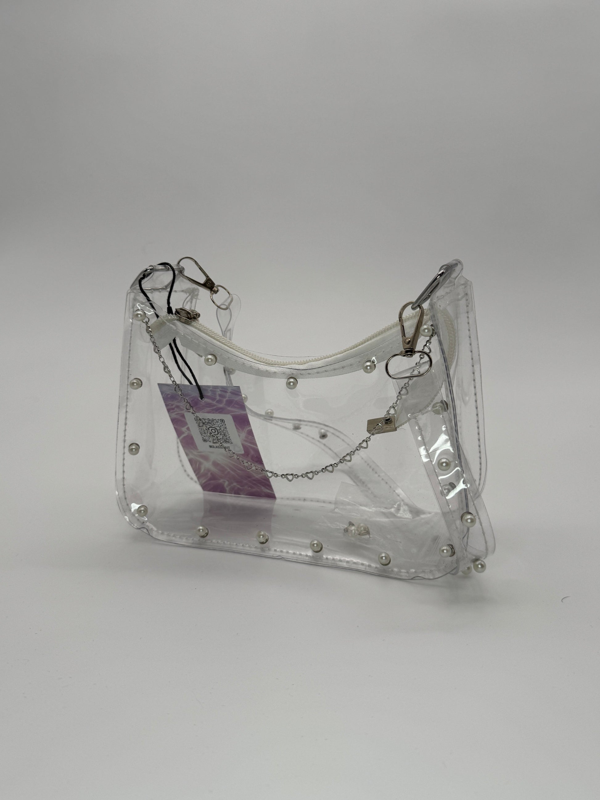 Clear jelly handbag with pearl studs on the front and across shoulder strap, and steel heart accent chain