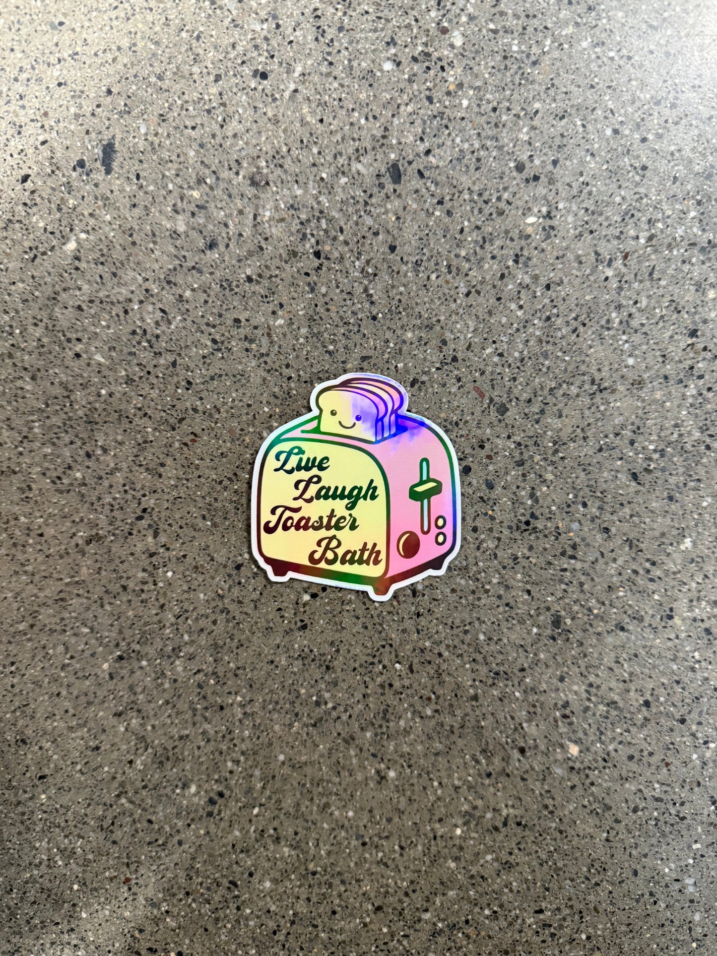 sticker with the image of a toaster that reads "live, laugh, toaster bath" 